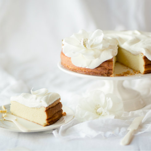 Baked ricotta cheesecake topped with freshly whipped cream (photography by Tasha Seccombe)
