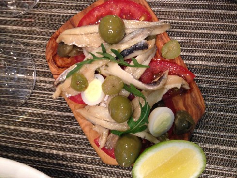 White anchovies, quails egg, manzanilla olives & tomato salad, caper dressing at Terra del Capo tapas restaurant.