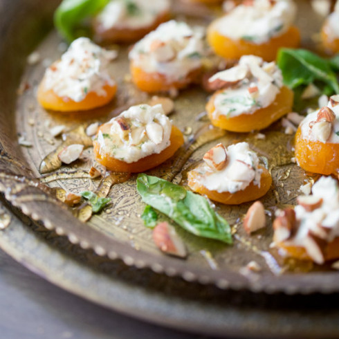 Soft dried apricots topped with basil goats cheese & almonds, drizzled with honey (photography by Tasha Seccombe)
