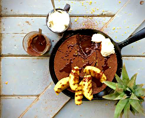 Baked chocolate pineapple pudding with almonds and orange rind, served with dark chocolate sauce & creme fraiche.