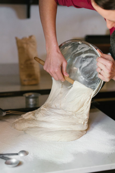 Transferring the proofed dough from the bowl to a floured surface. As you can see, it is very runny. (photography by Tasha Seccombe)