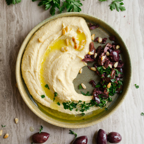 Creamy hummus with olive oil, pine nuts, parsley & crushed olives (photography by Tasha Seccombe)